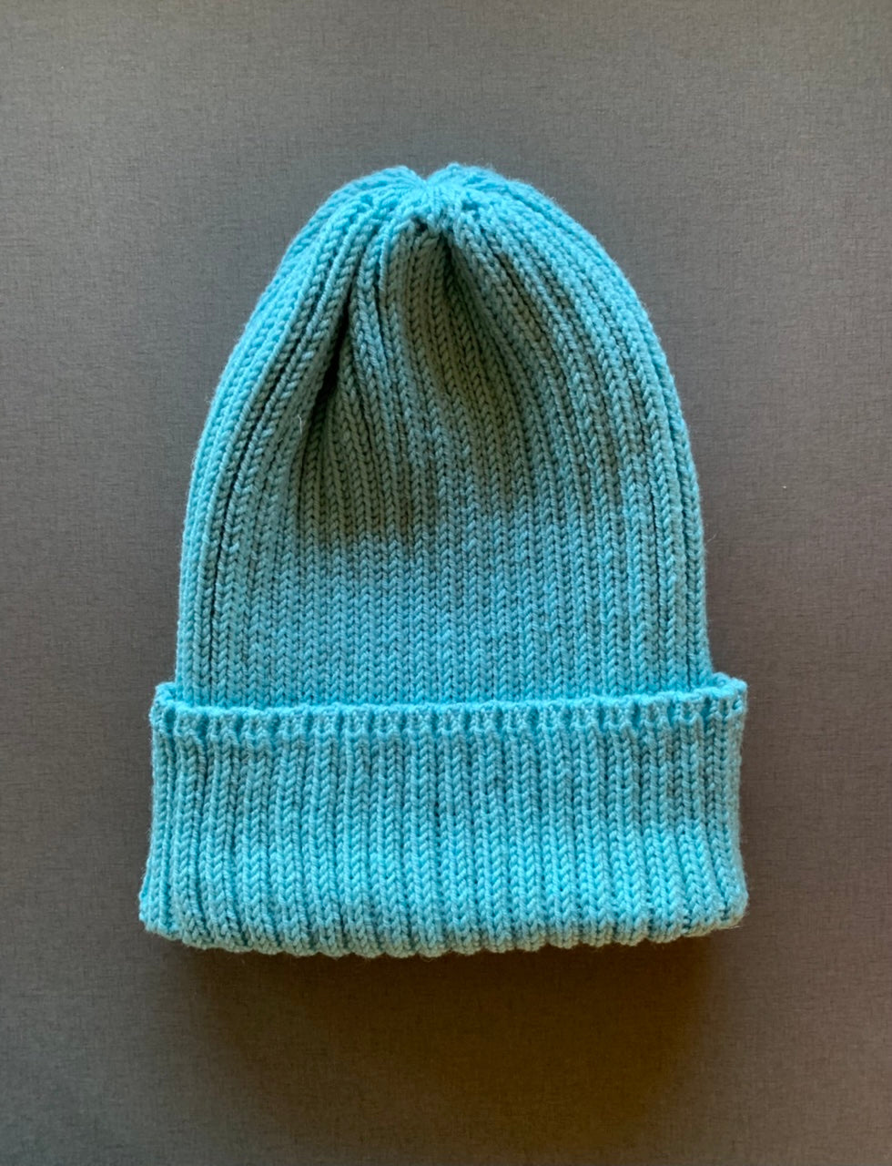 Turquoise knitted merino wool beanie for spring and autumn