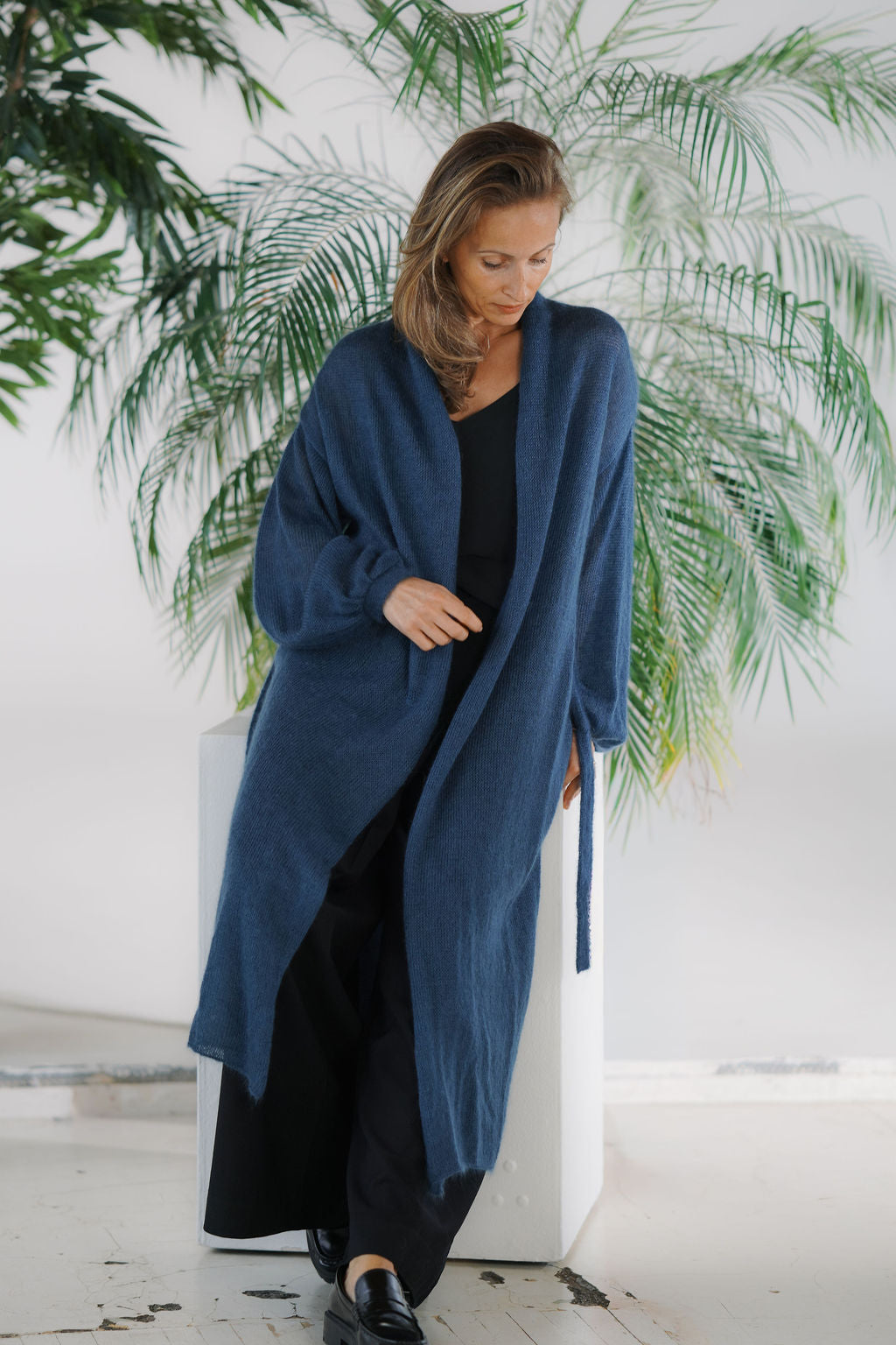 Women’s knitted kid mohair and silk long cardigan worn open with puff sleeves and belt