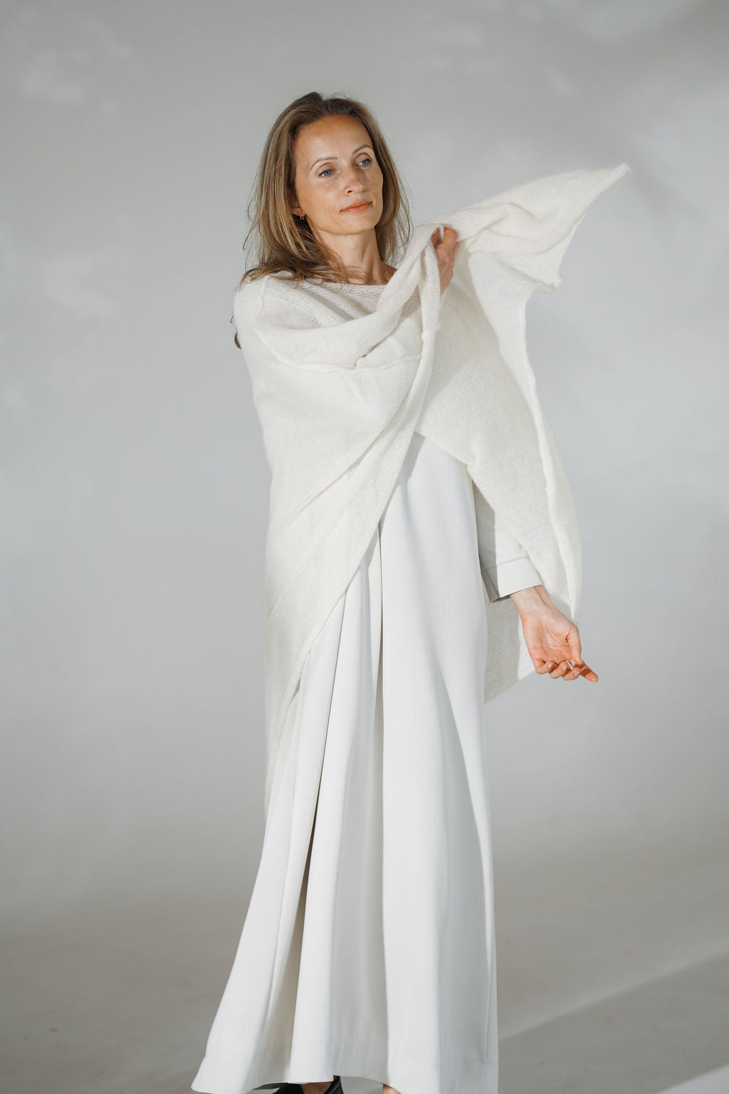 Women's mohair poncho with asymmetric hem